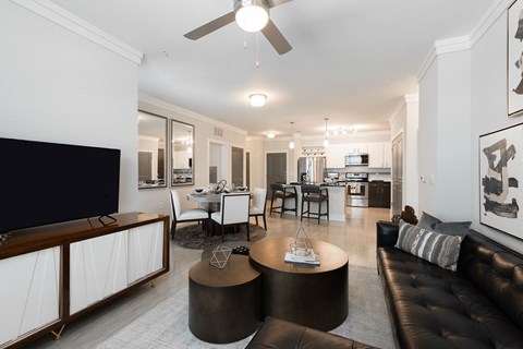 a living room with a leather couch and a tv